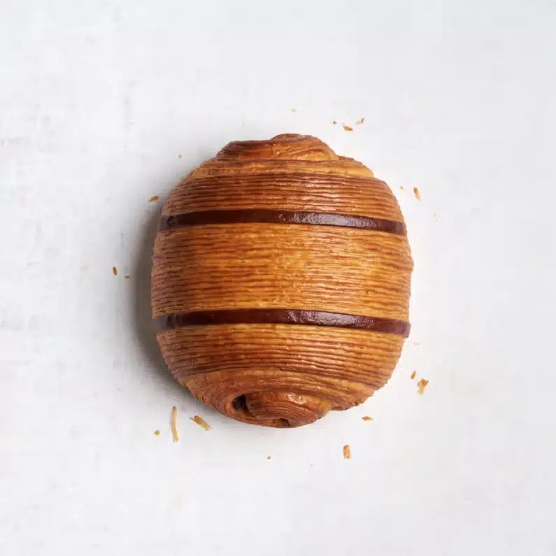 Delicious Pain au Chocolat pastries in a small bakery box, featuring a rich chocolate filling and a buttery, flaky exterior