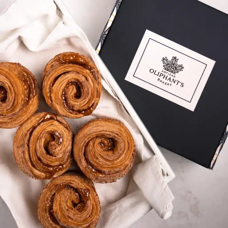 Artisan cinnamon rolls in a small bakery box, perfect for gifting, available for nationwide delivery, and crafted by award-winning London bakery