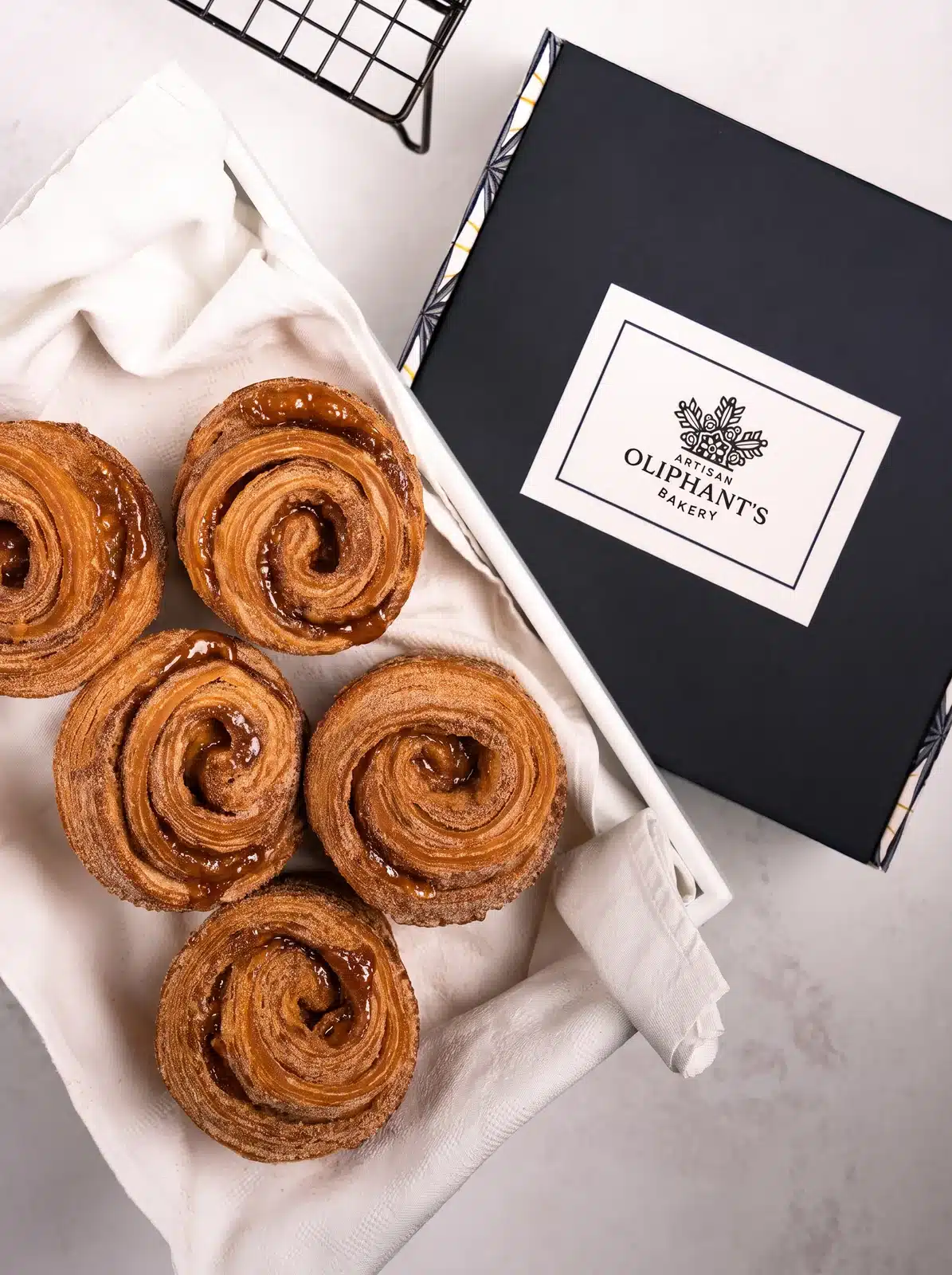 Artisan cinnamon rolls in a small bakery box, perfect for gifting, available for nationwide delivery, and crafted by award-winning London bakery
