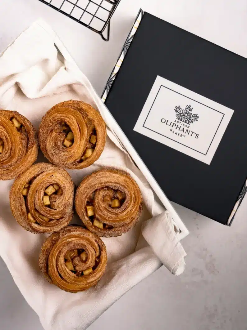 Apple cinnamon pastries in a small bakery box, offering a delightful blend of spiced apple and buttery pastry