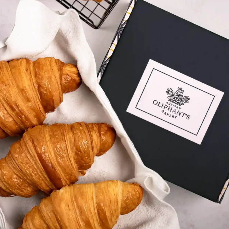 Classic plain croissants in a compact bakery box, offering a deliciously flaky and buttery treat for any occasion
